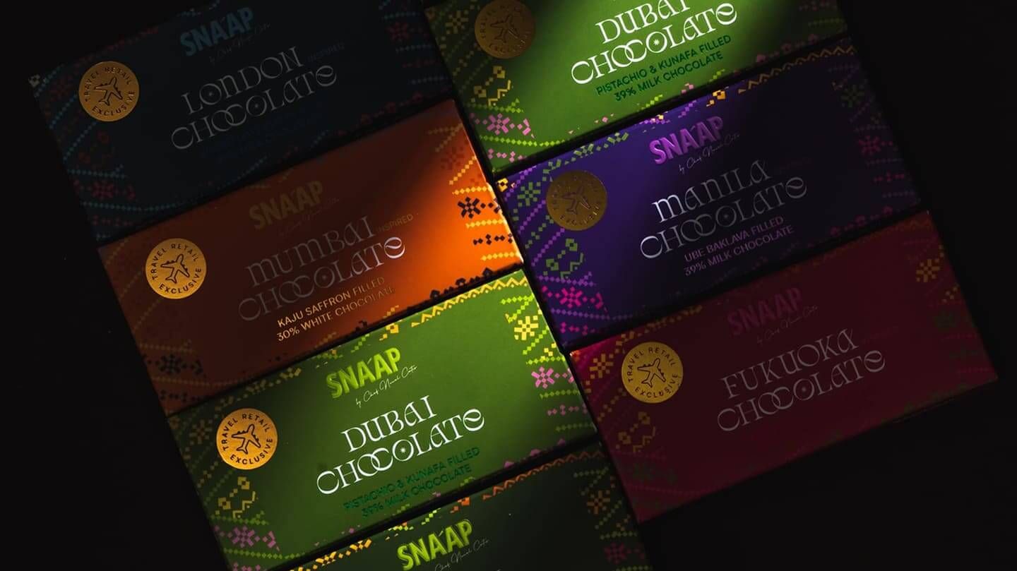 City chocolate collection laid out on a dark surface