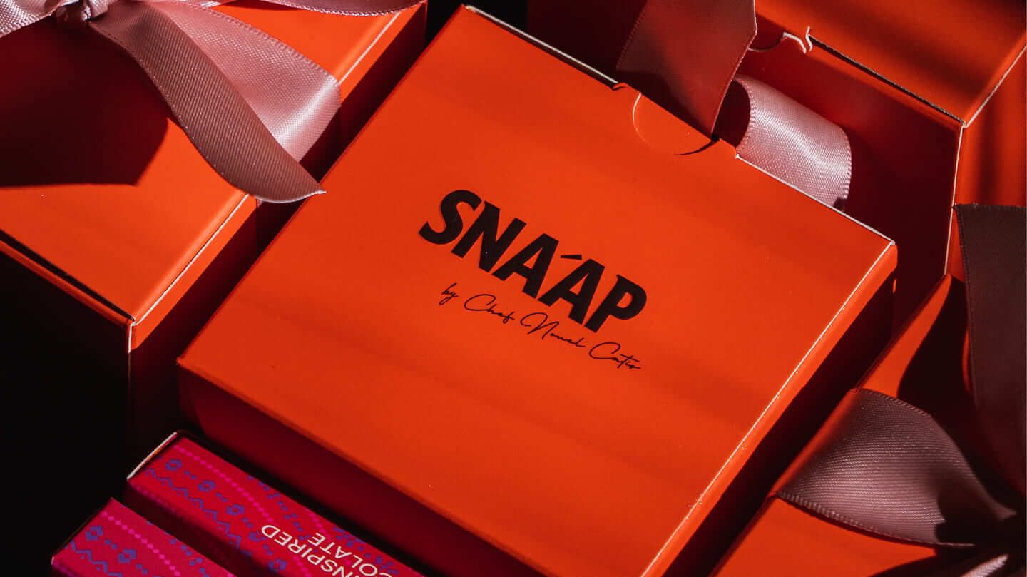 Orange SNA’AP gift box with ribbon
