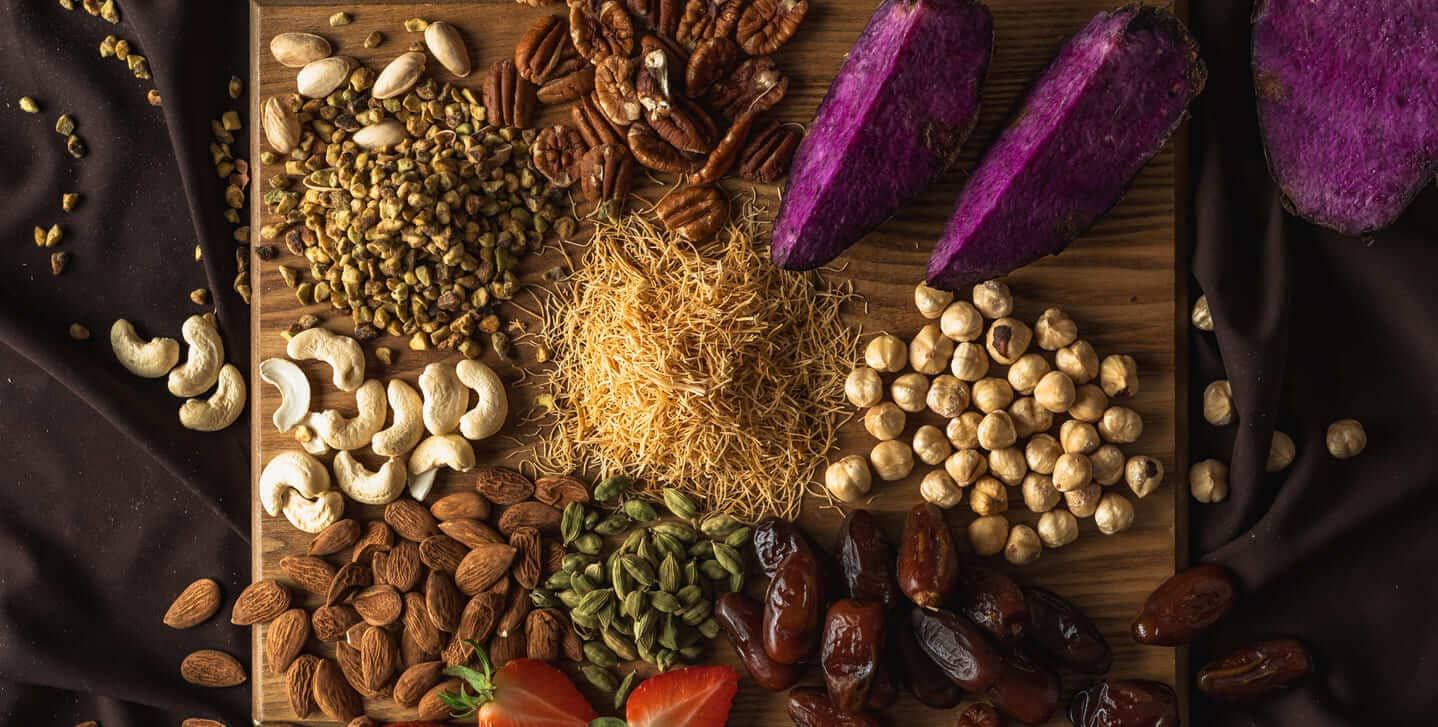 Pistachios, nuts, dates and spices on a board