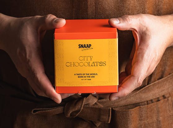 Hands holding a City Chocolates box